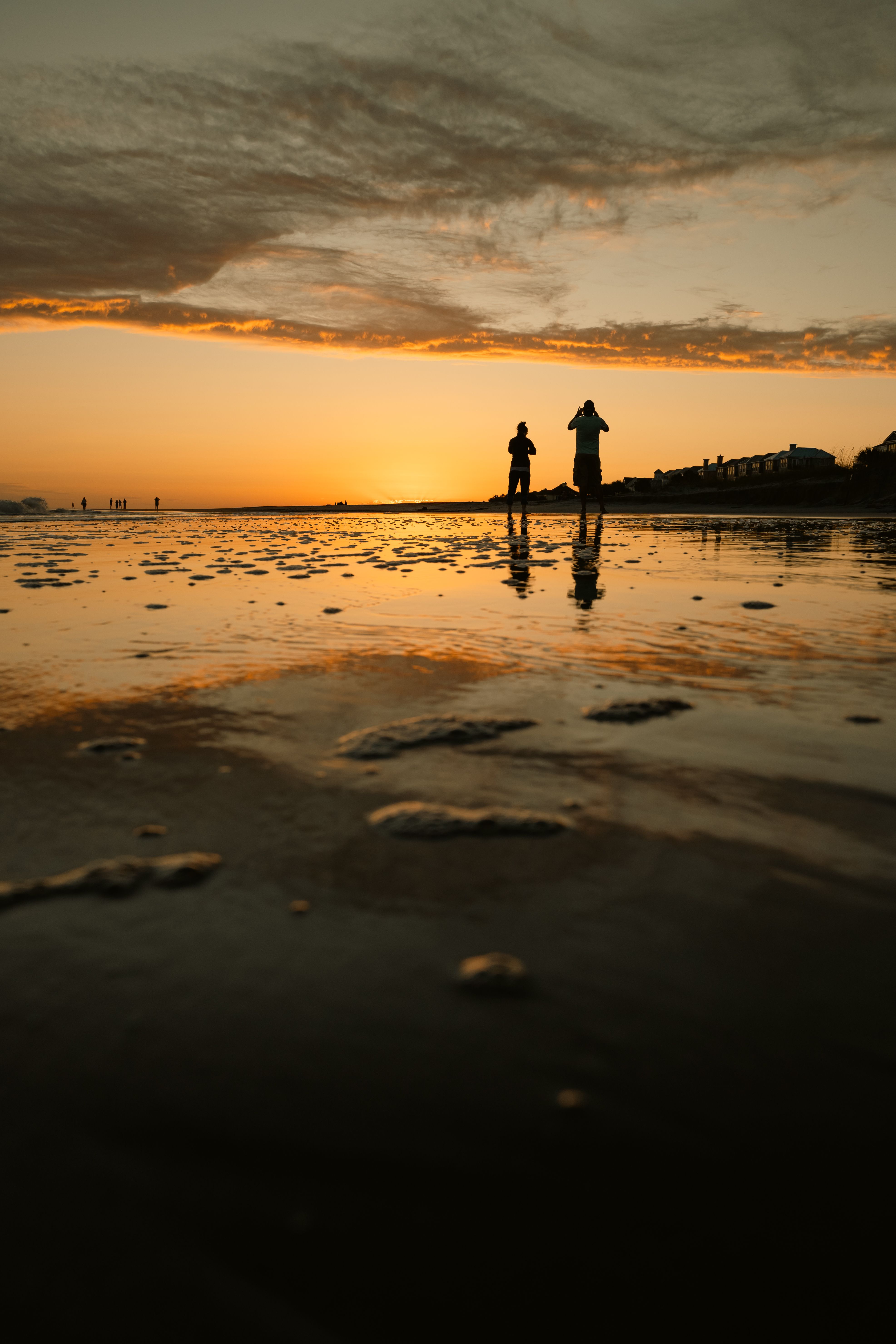 Two People Enjoying a Scenic Beach Sunset Reflection · Free Stock Photo