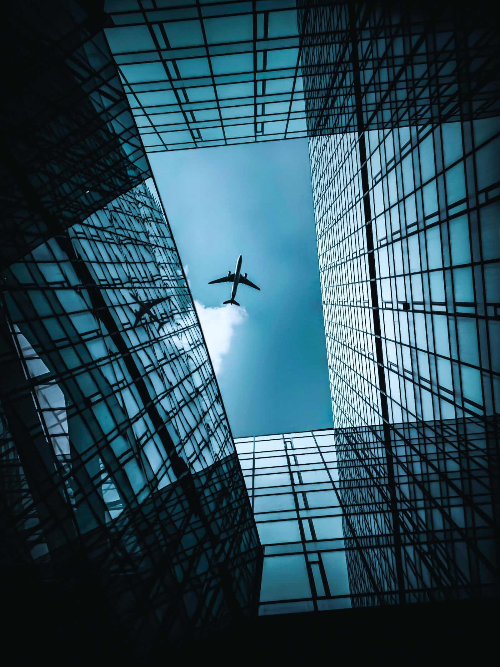 Airplane Near Blue and Grey Building · Free Stock Photo