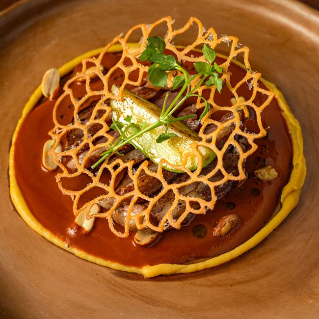 Elegant gourmet dish featuring unique lattice garnish and vibrant plating. (Photo: Photo by Leonardo Aquino on Pexels)