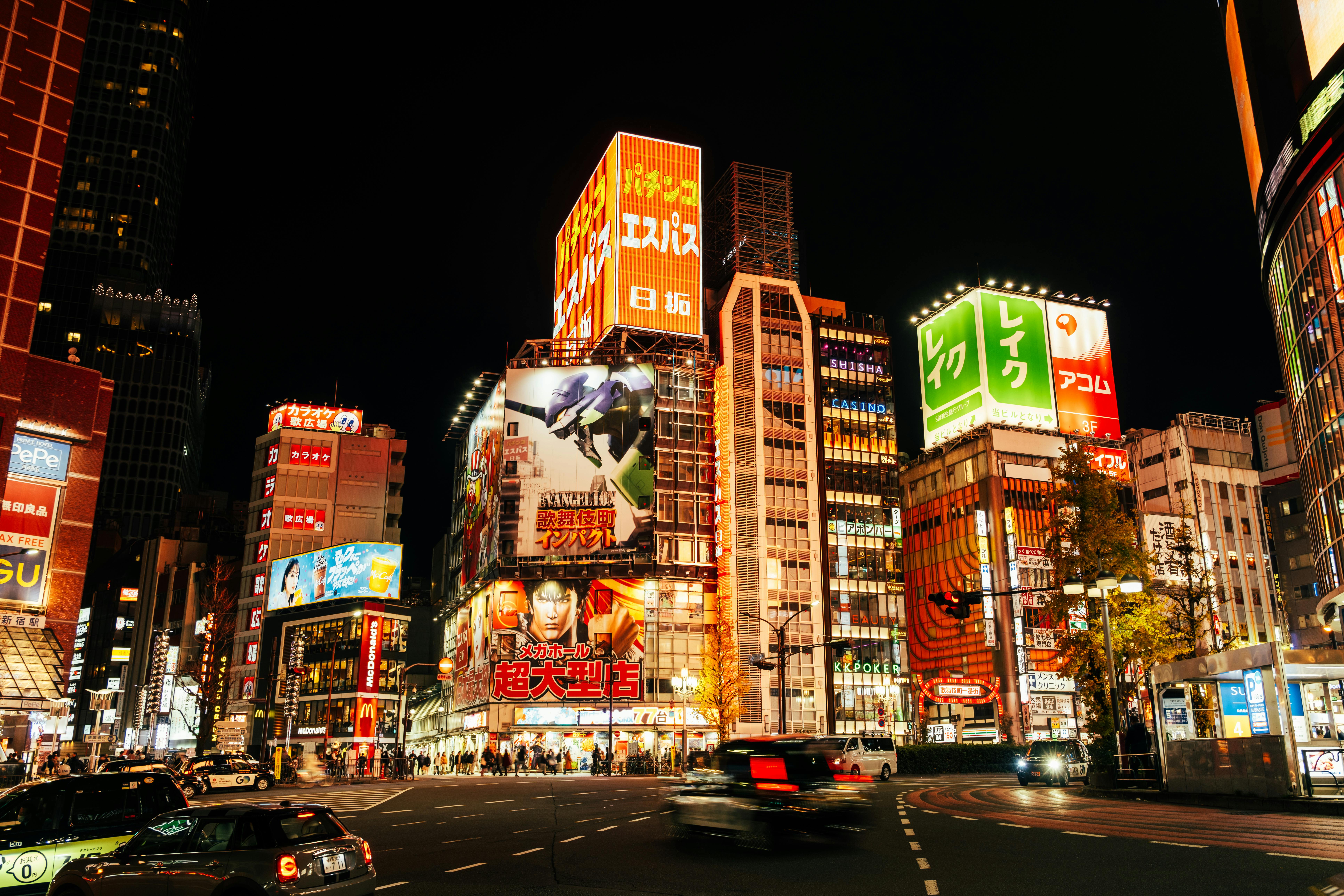 Bright cityscape of Shinjuku, Tokyo, showcasing vibrant neon lights and bustling streets.