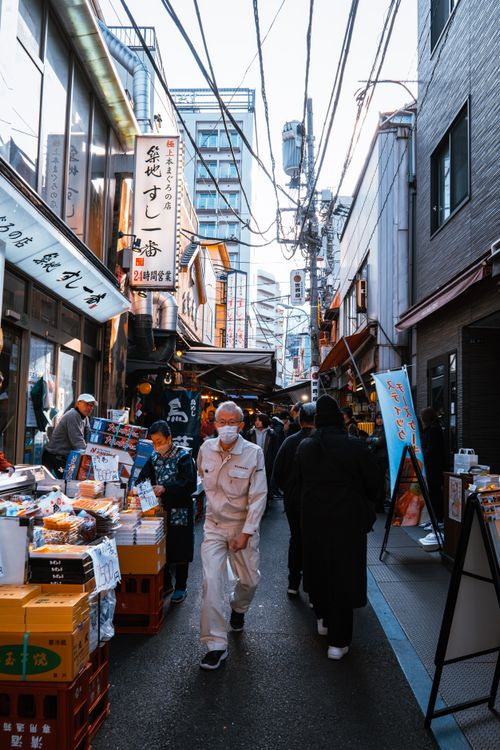 Free Vivid street market scene in Tokyo with people shopping and vibrant signage. Stock Photo