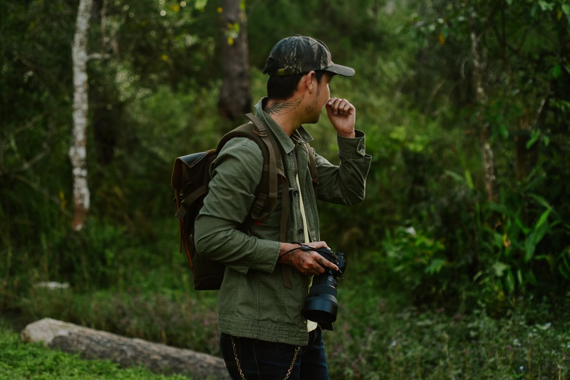 Photographers Exploring Nature Photographer Exploring Forest Scene · Free Stock Photo