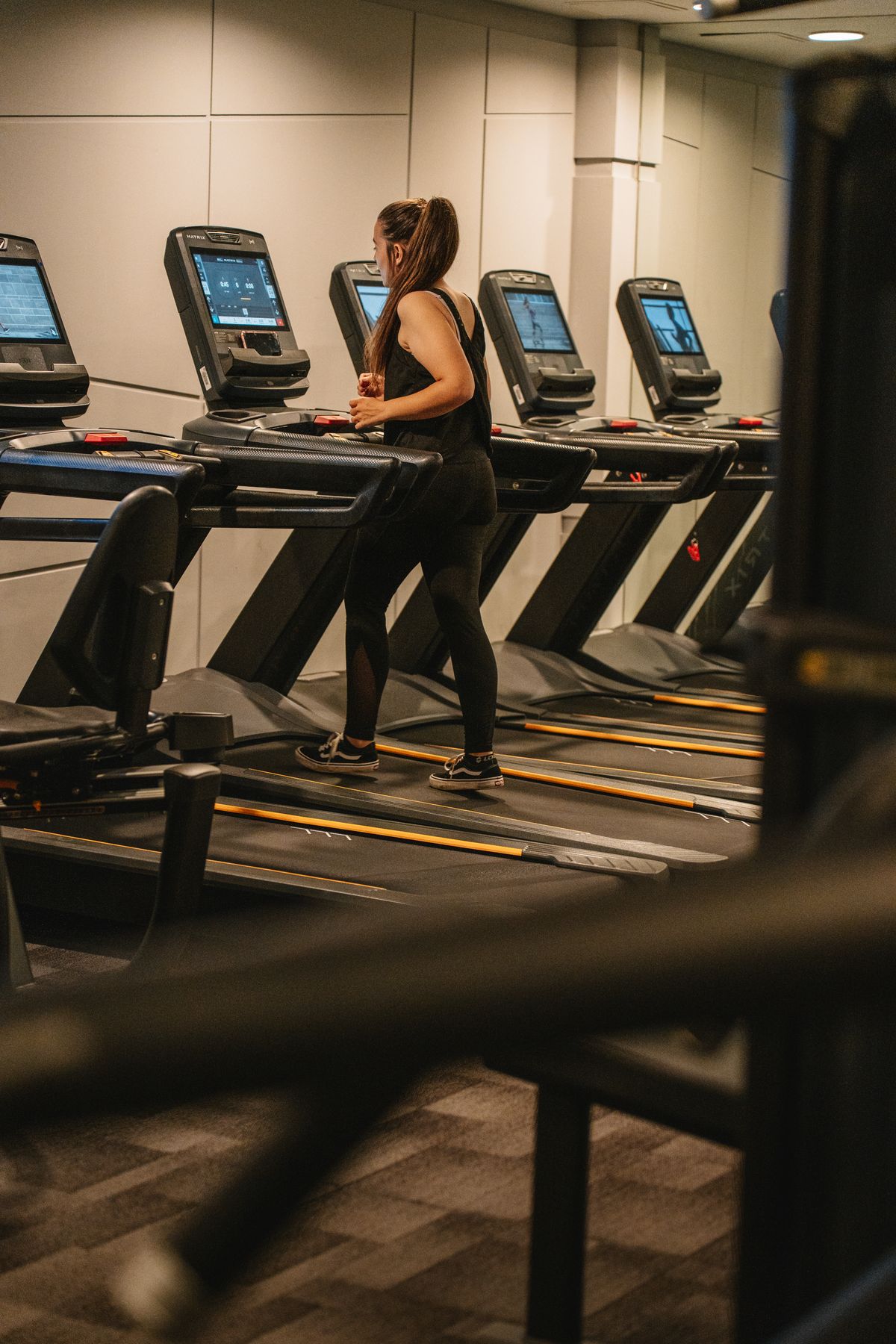 Athlete exercising on a treadmill in a modern fitness facility