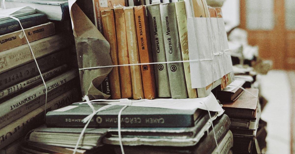 A stack of vintage books tied with string in Talgar, Kazakhstan library.