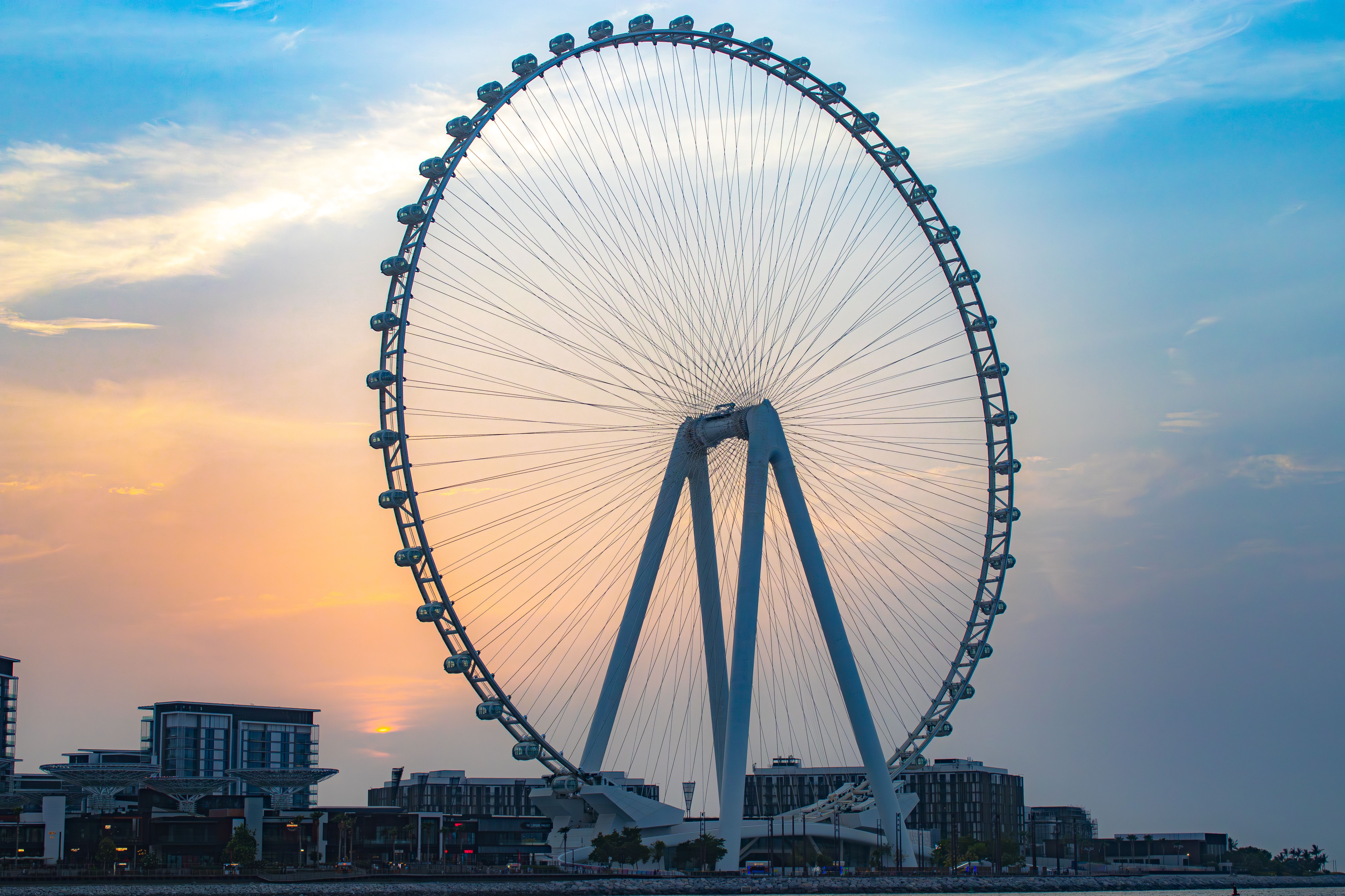 Stunning view of Ain Dubai Ferris Wheel with a vibrant sunset sky in the background in Dubai, UAE.