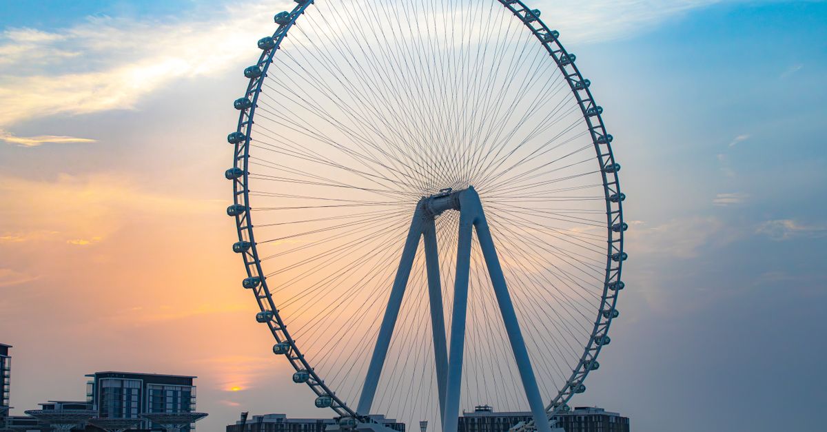 Stunning view of Ain Dubai Ferris Wheel with a vibrant sunset sky in the background in Dubai, UAE.