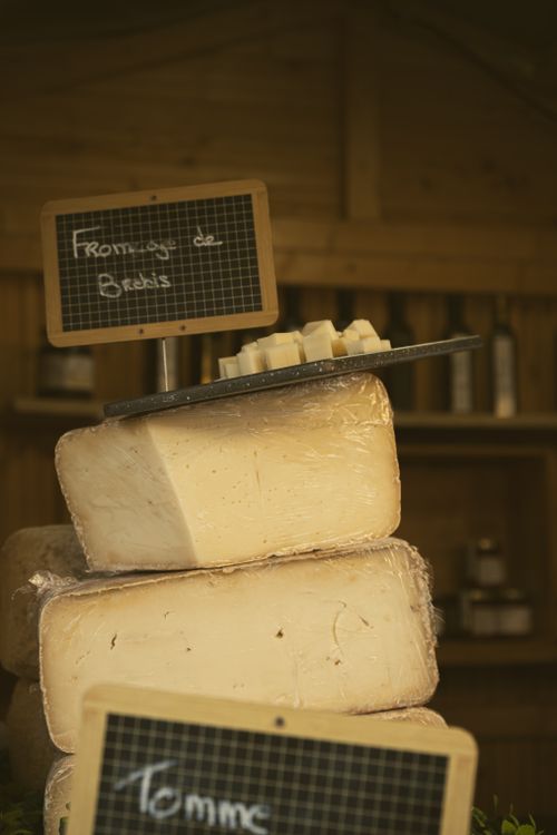Free A rustic display of hard cheeses at a Marckolsheim market stall, showcasing gourmet craftsmanship. Stock Photo