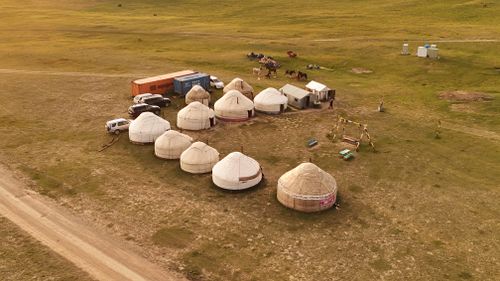 Free Scenic aerial shot of yurts and cars in Naryn, Kyrgyzstan, during daylight. Stock Photo