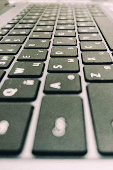 Detailed close-up of a modern black laptop keyboard with Cyrillic letters.