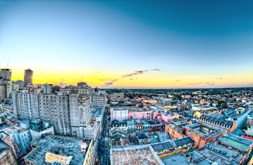 Free A colorful aerial view of New Orleans cityscape during sunset, showcasing historic buildings and skyline. Stock Photo