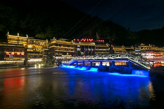 Stunning view of illuminated traditional Chinese buildings and a bridge at night.