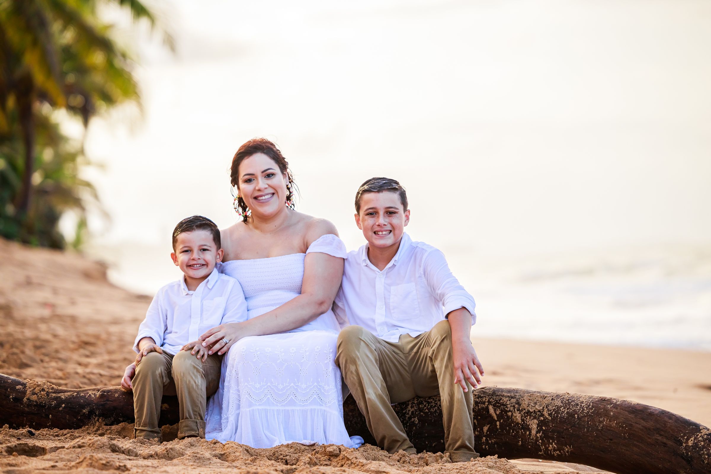 A family portrait on a tropical beach in warm daylight