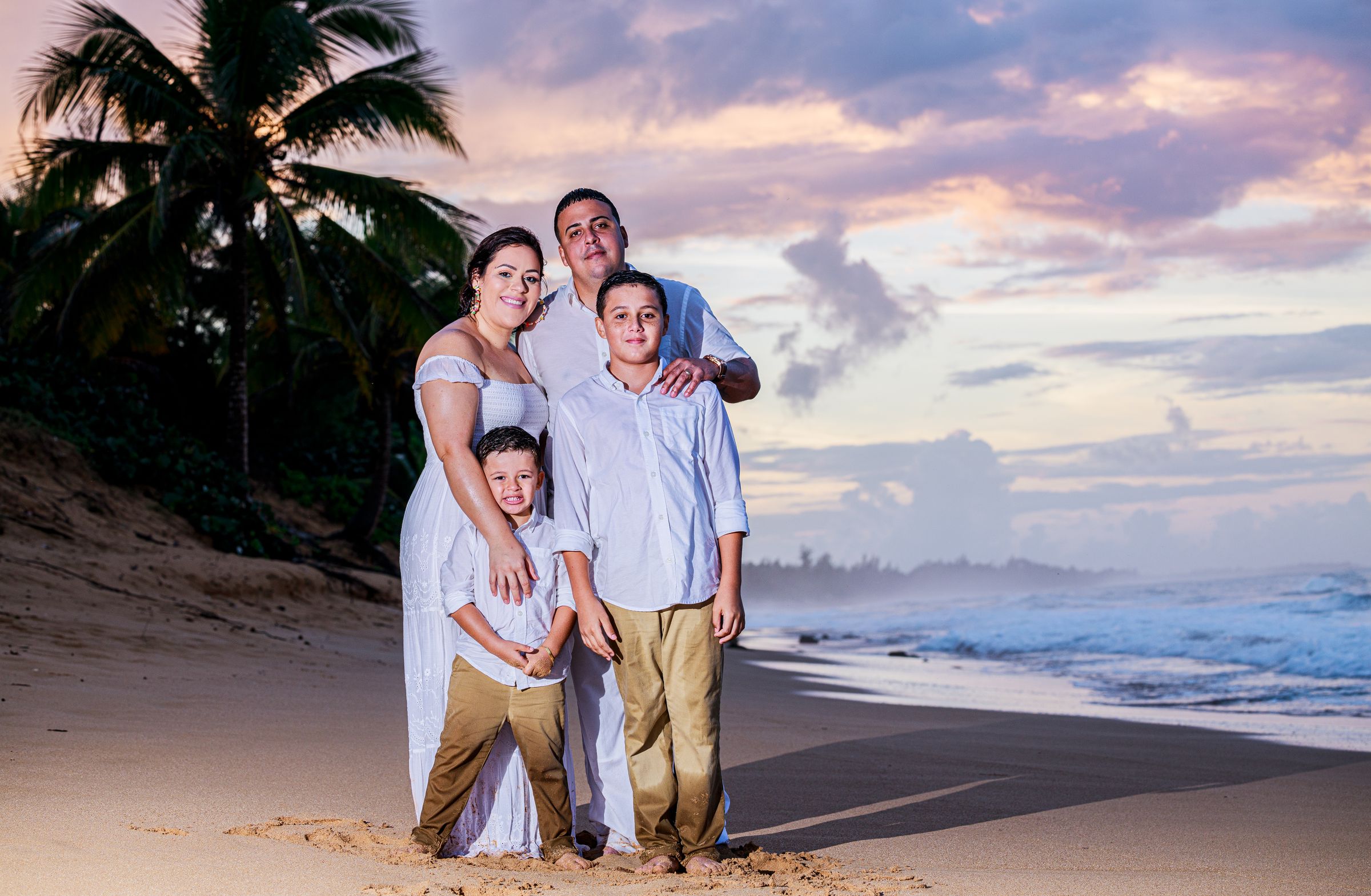 A Puerto Rican family dressed in white, gathered at golden hour to mark an occasion