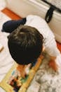Child Playing with Colorful Puzzle on Floor