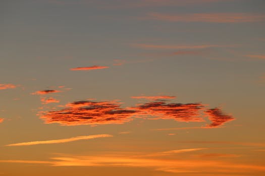 Vibrant autumn sky in Stamford, Connecticut at dawn with pink clouds.