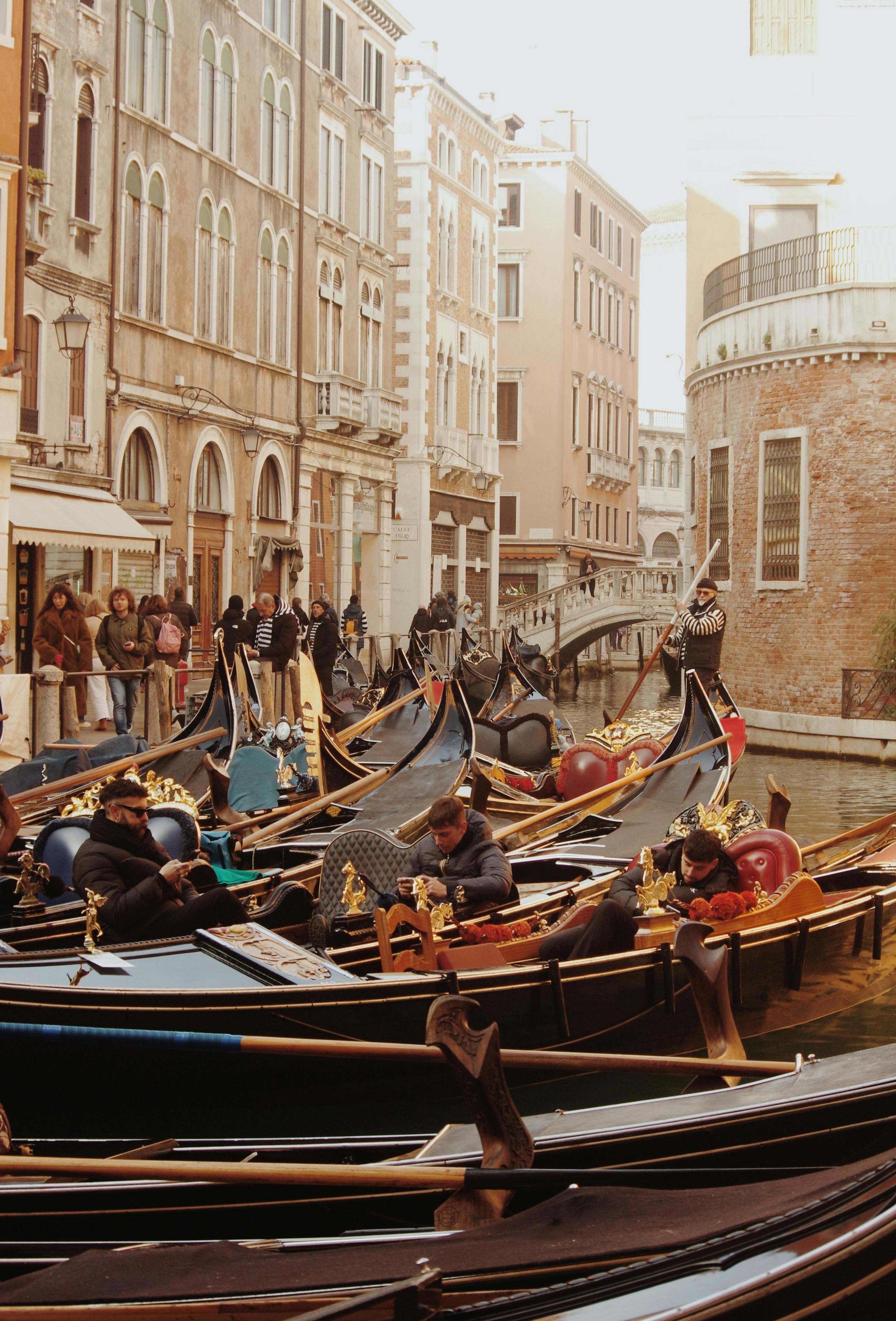 Gondolas line a picturesque Venetian canal surrounded by historic architecture in Venice, Italy.