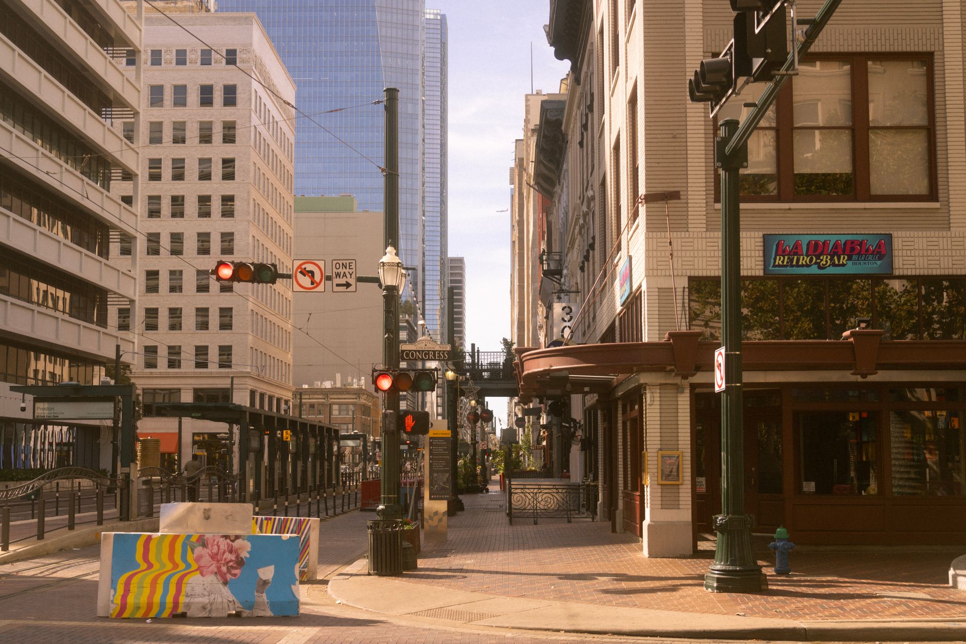 A vibrant corner in downtown Houston featuring street art and historic architecture.