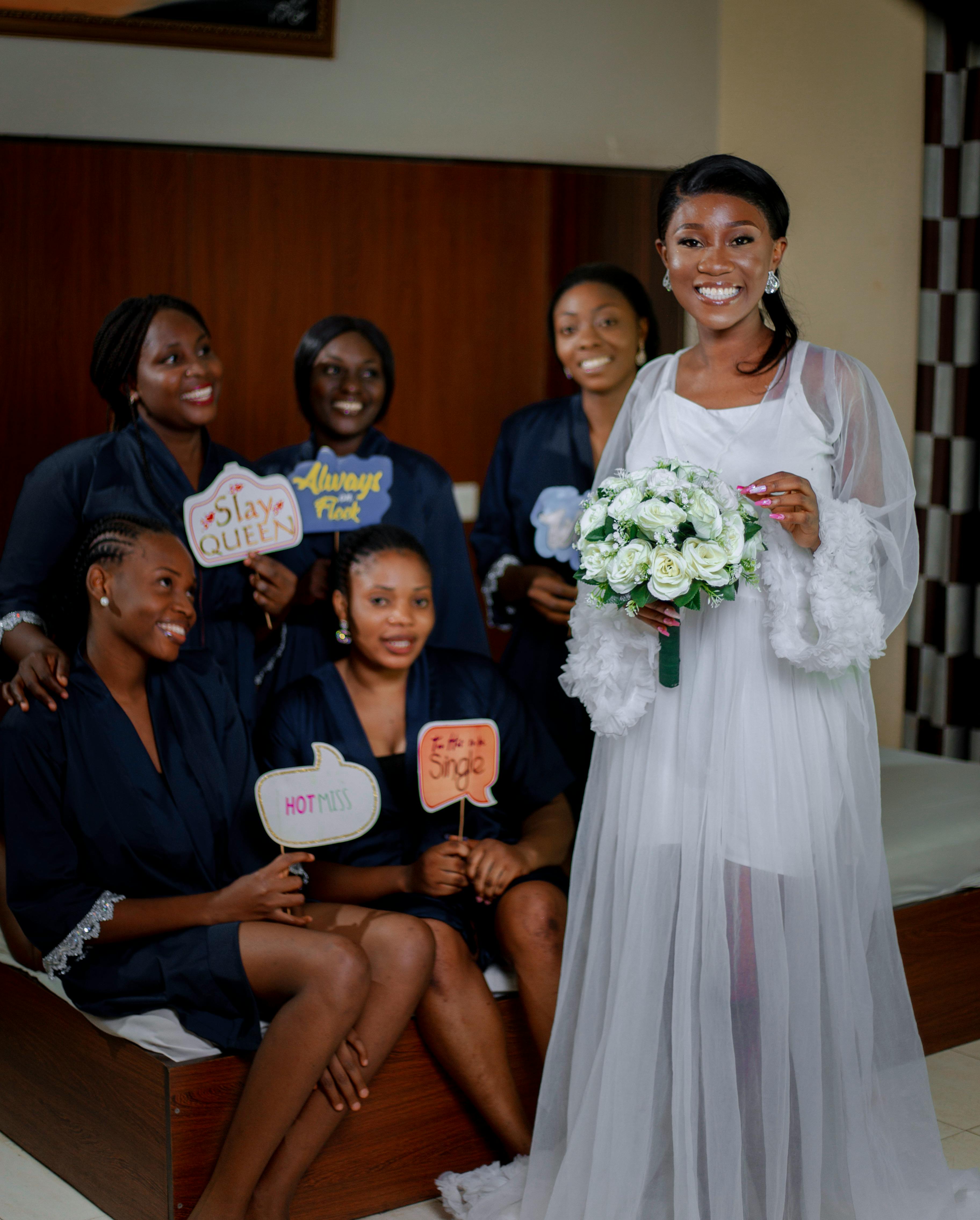 Bride and bridesmaids celebrating a bridal shower with fun props and joy.