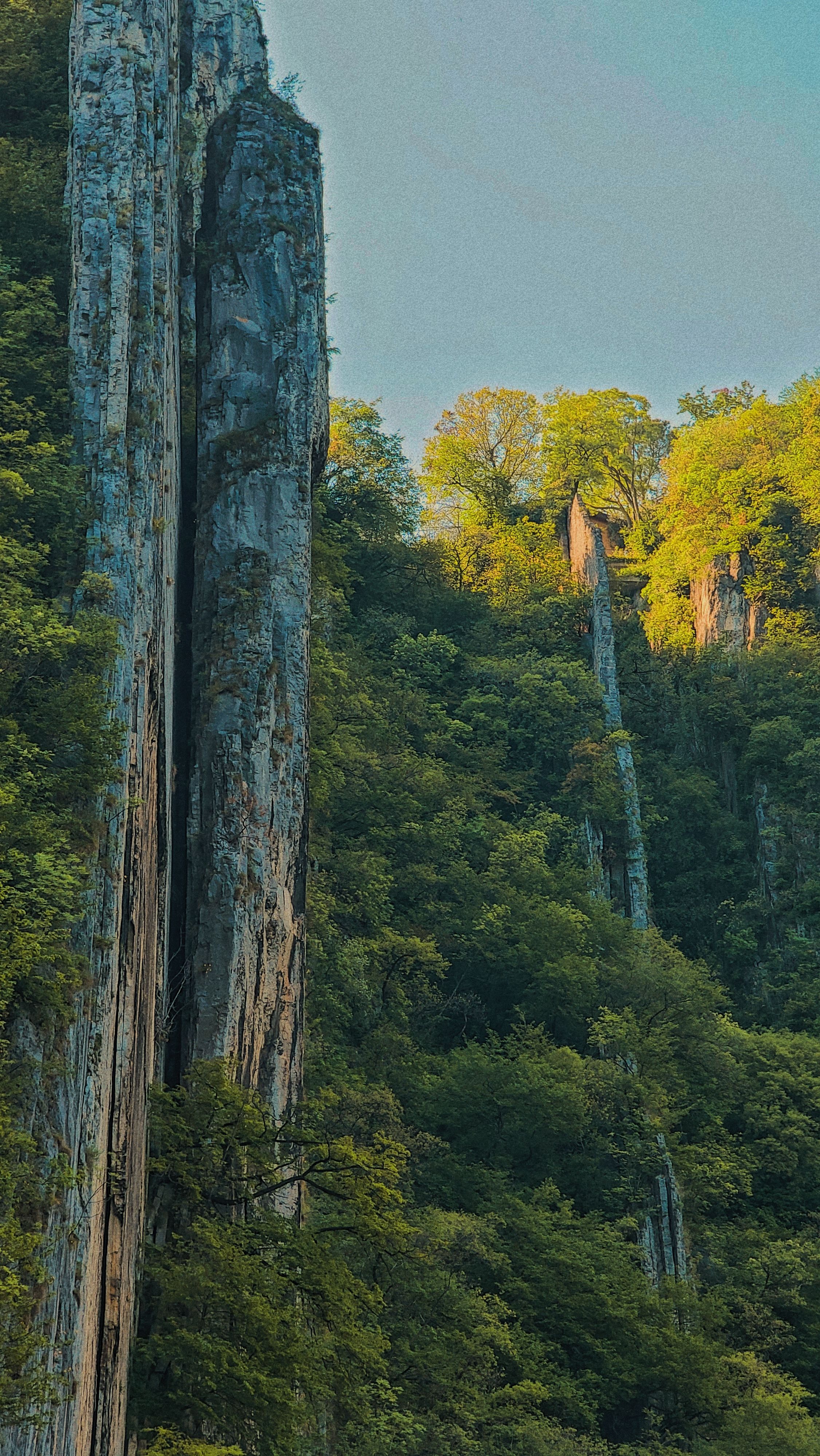 Stunning cliffs surrounded by lush greenery in Lovere, Lombardy, Italy, showcasing nature's beauty.