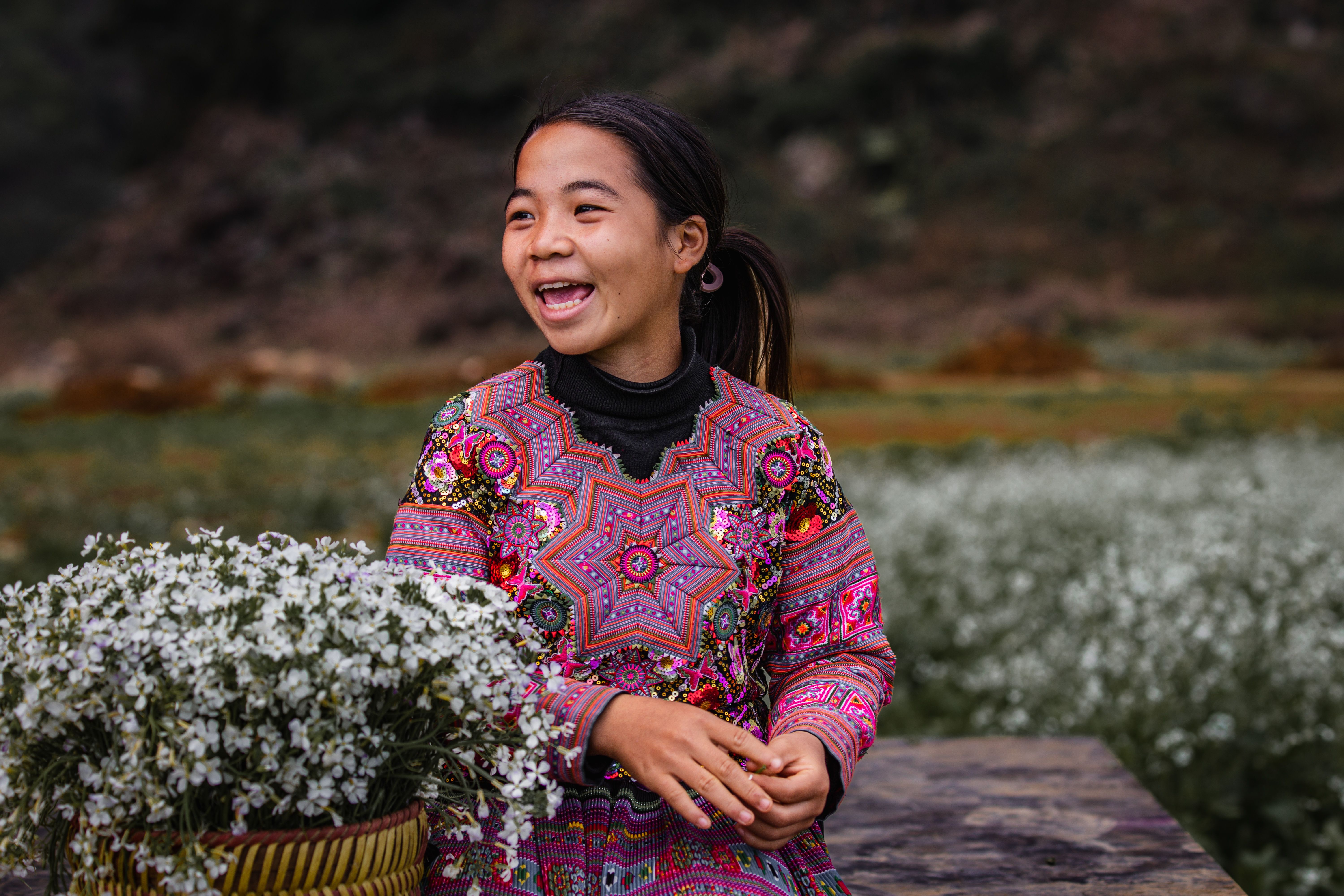Smiling Woman in Colorful Traditional Dress Among Flowers · Free Stock ...