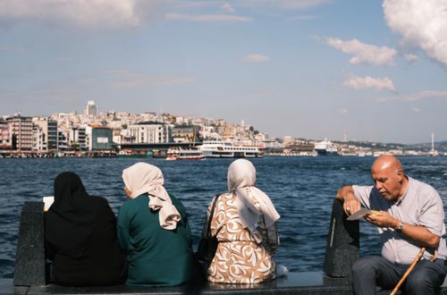 Free Locals enjoy a day by the Bosphorus in İstanbul, showcasing the city's vibrant waterfront and skyline. Stock Photo