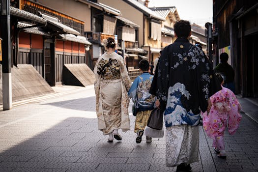 A Japanese family in colorful kimonos walking through a historic street in Kyoto, Japan.