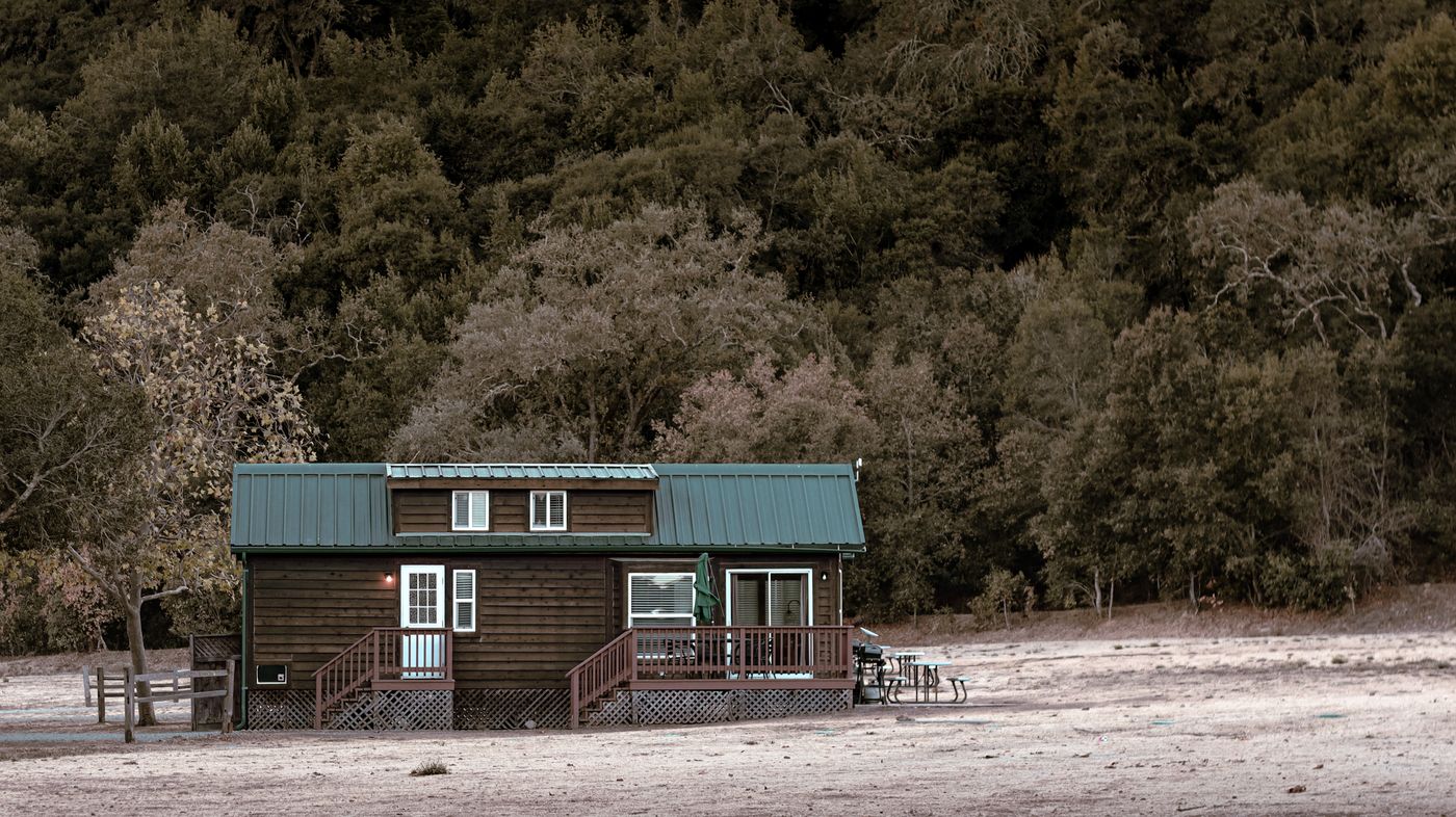 Modern tiny home cottage â€” standing-seam roof, board-and-batten siding