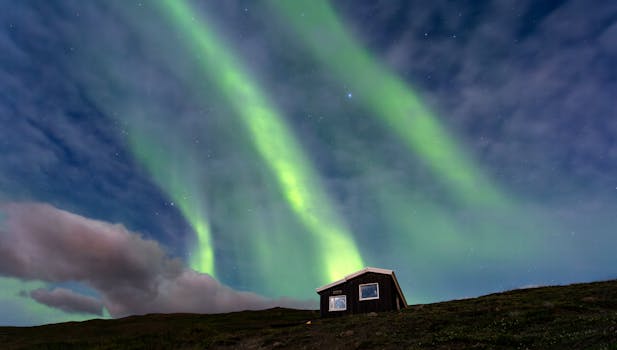 Beautiful aurora borealis above a cabin in Akureyri, Iceland at night.