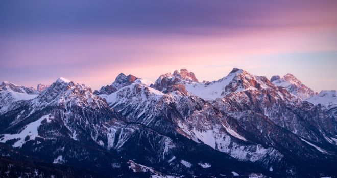 Breathtaking view of the snowy Dolomites in Trentino-South Tyrol, Italy during sunset.