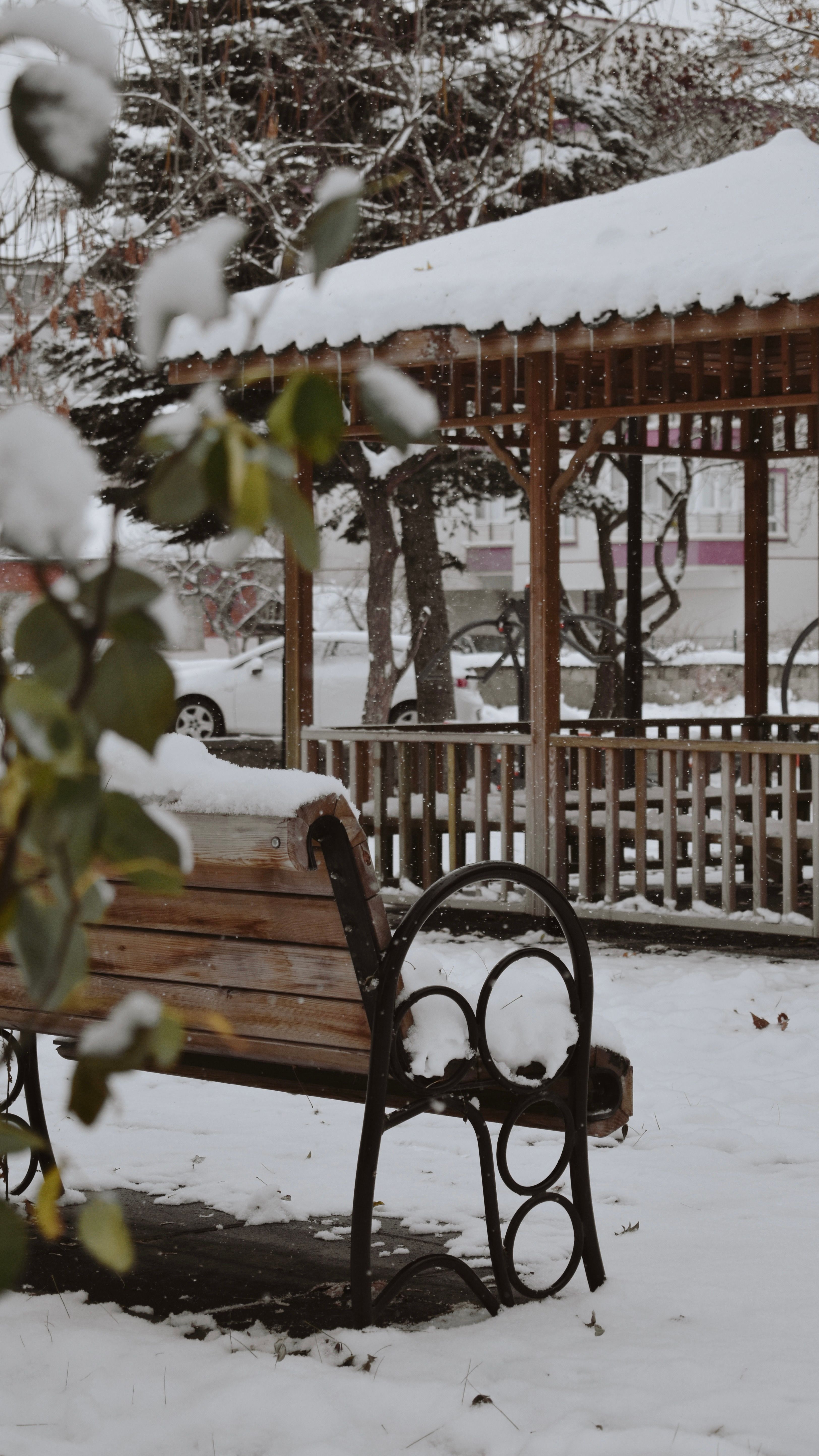 Snow-Covered Wooden Gazebo and Bench in Winter Park · Free Stock Photo