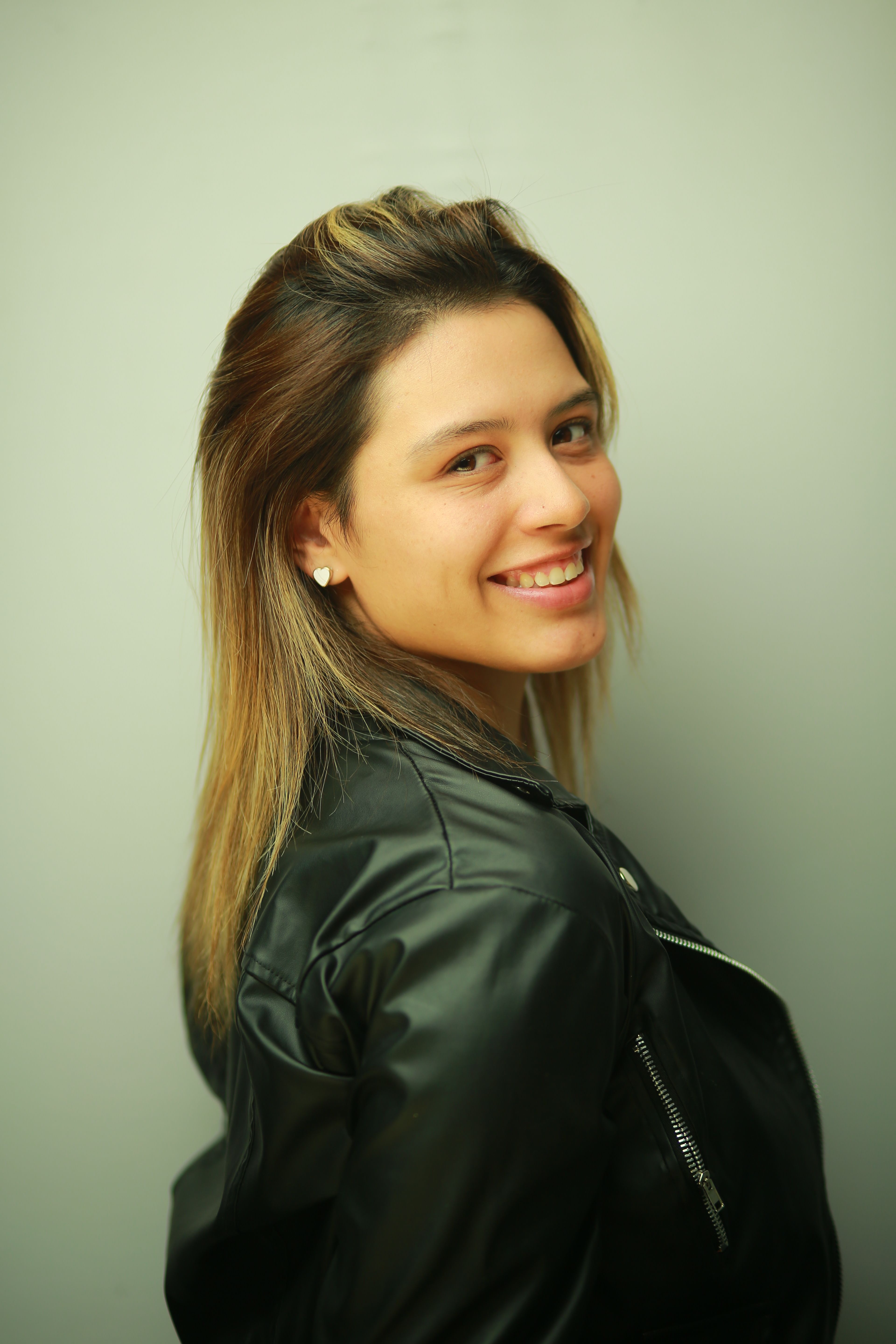 Portrait of a Smiling Woman in a Leather Jacket · Free Stock Photo