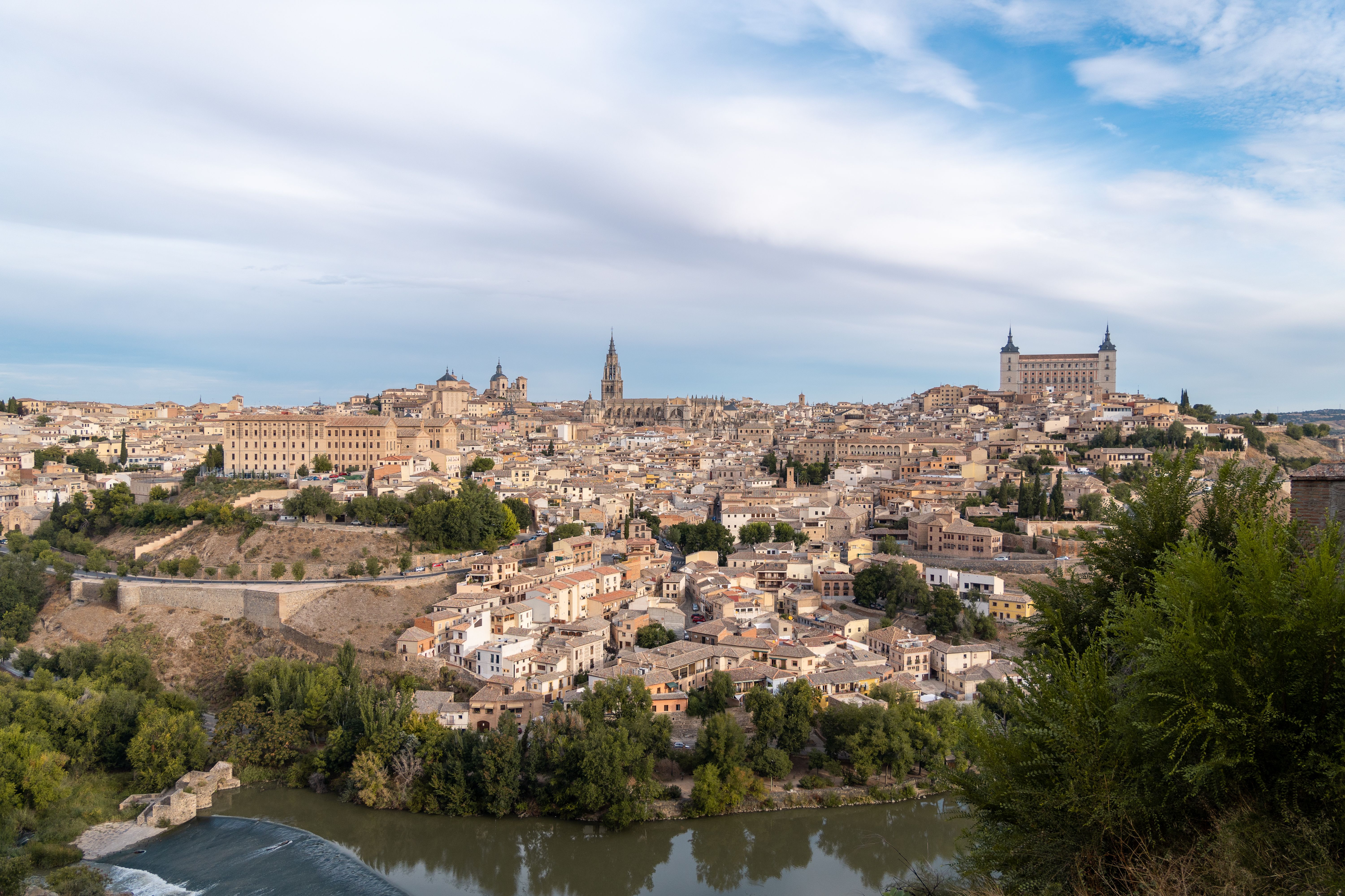 Discover the breathtaking aerial view of Toledo, showcasing its historic architecture and Tajo River.