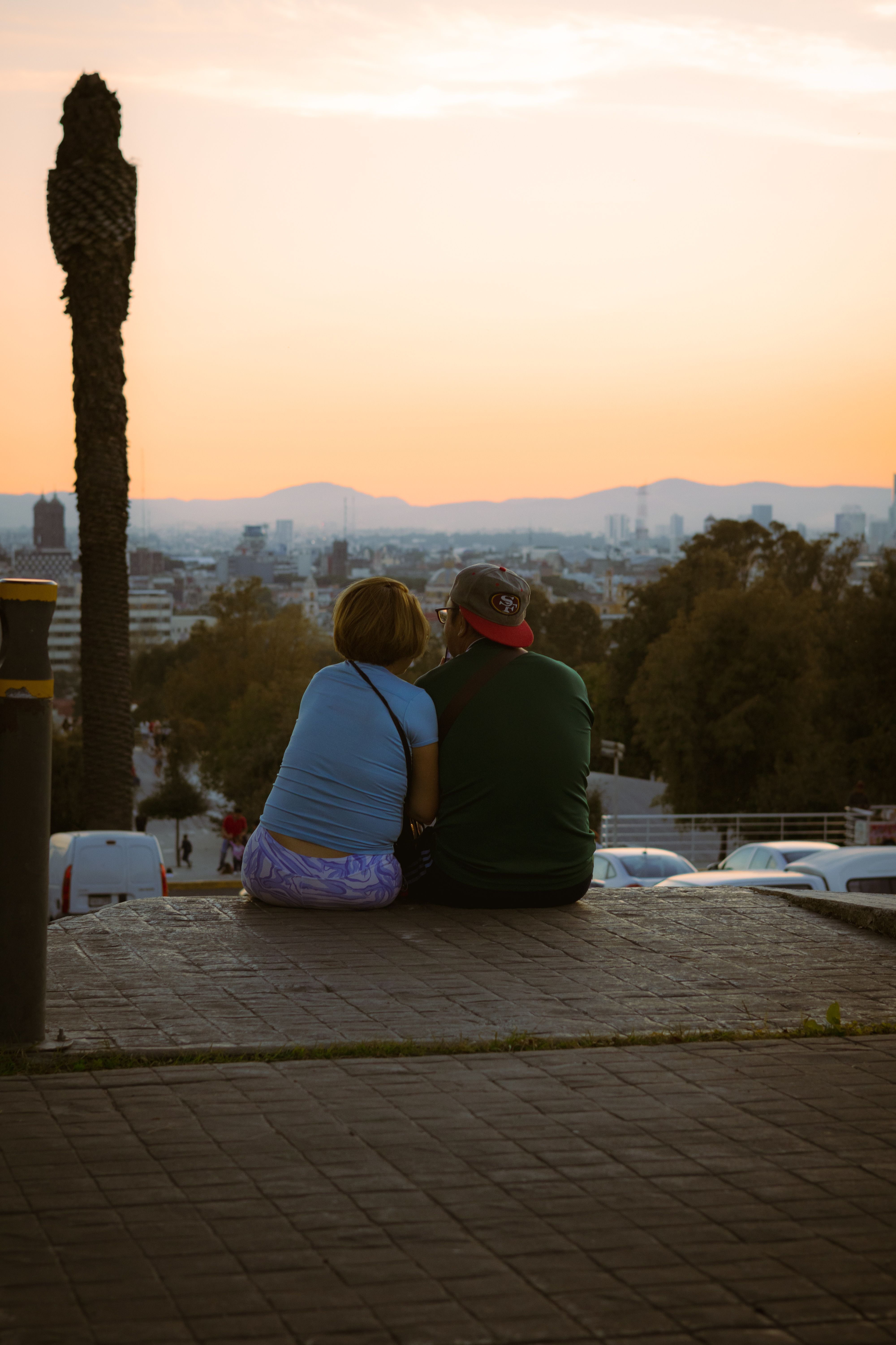 Couple enjoying a city sunset from above