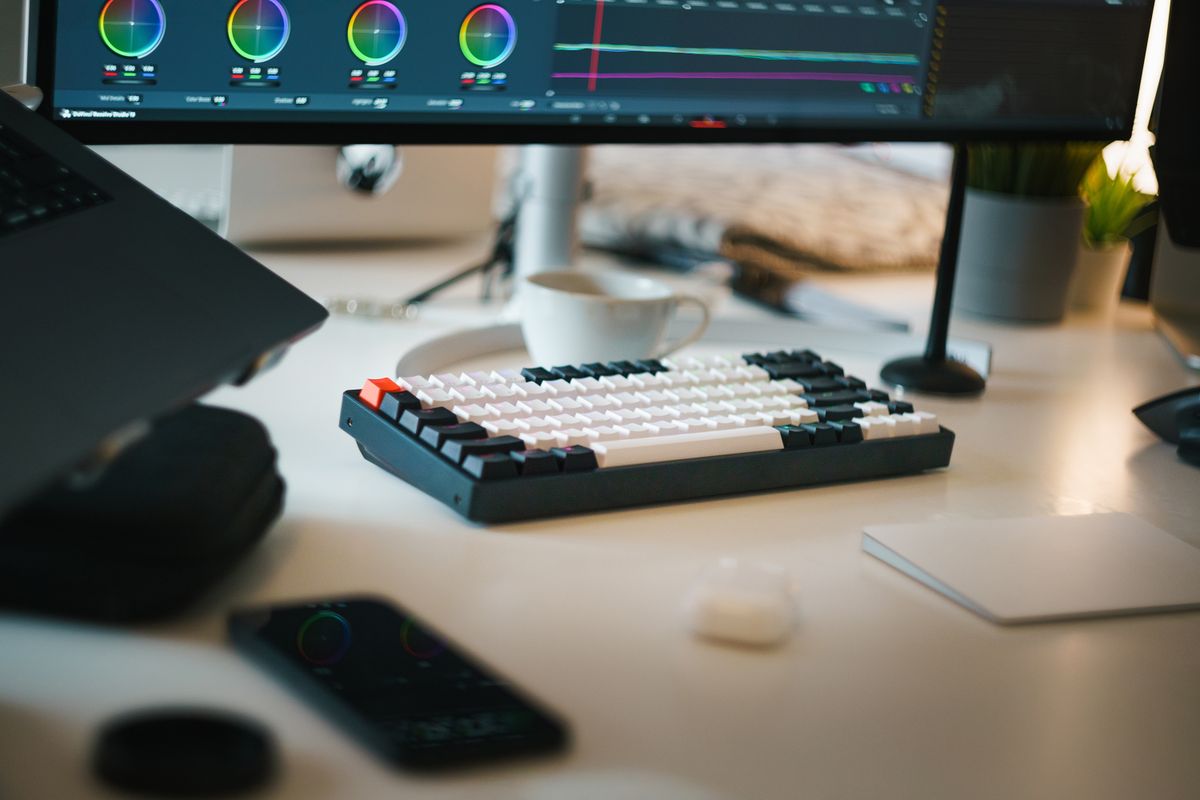 A Man Sitting on Front of the Computer while Editing Video · Free Stock ...
