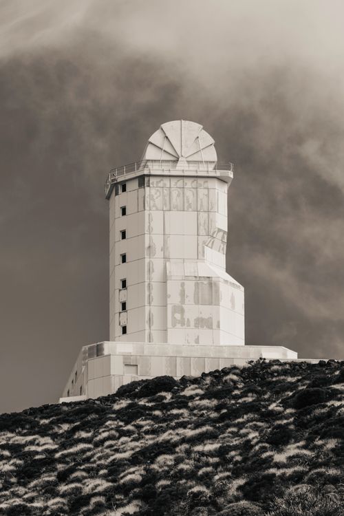 Free Dramatic black and white image of the Tenerife Observatory tower under moody skies. Stock Photo