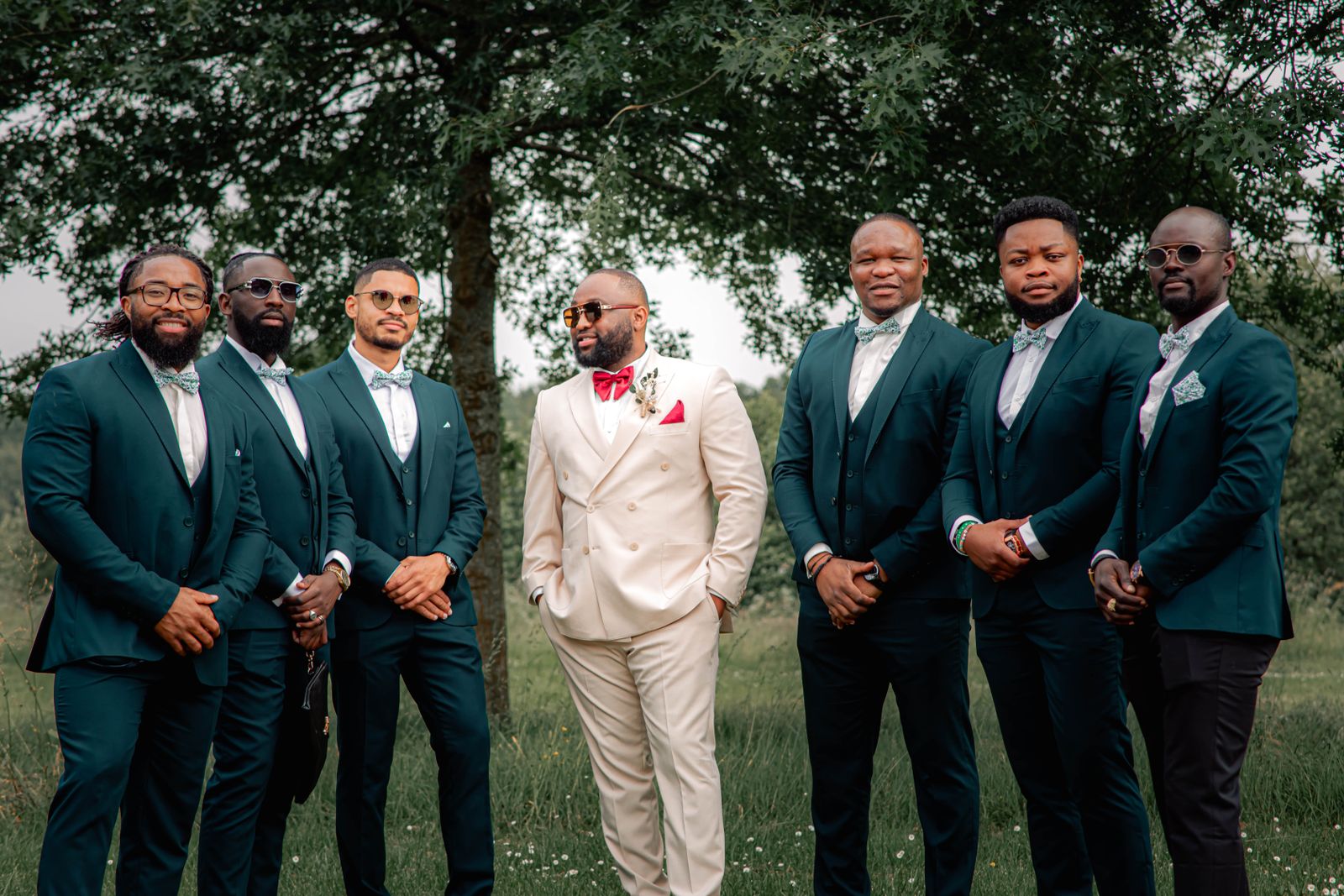 groomsmen in teal suits posing outdoors