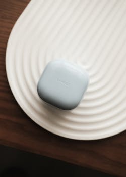 Simple and elegant display of Laneige beauty product on textured white surface.