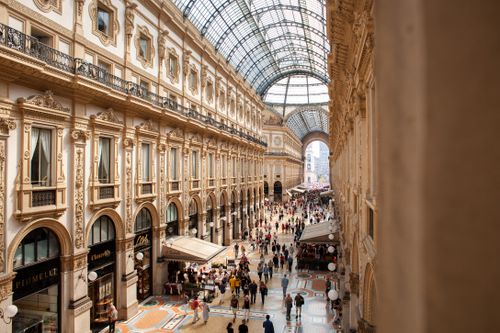 Free Interior view of Galleria Vittorio Emanuele II in Milan, showcasing its stunning architecture and bustling crowds. Stock Photo