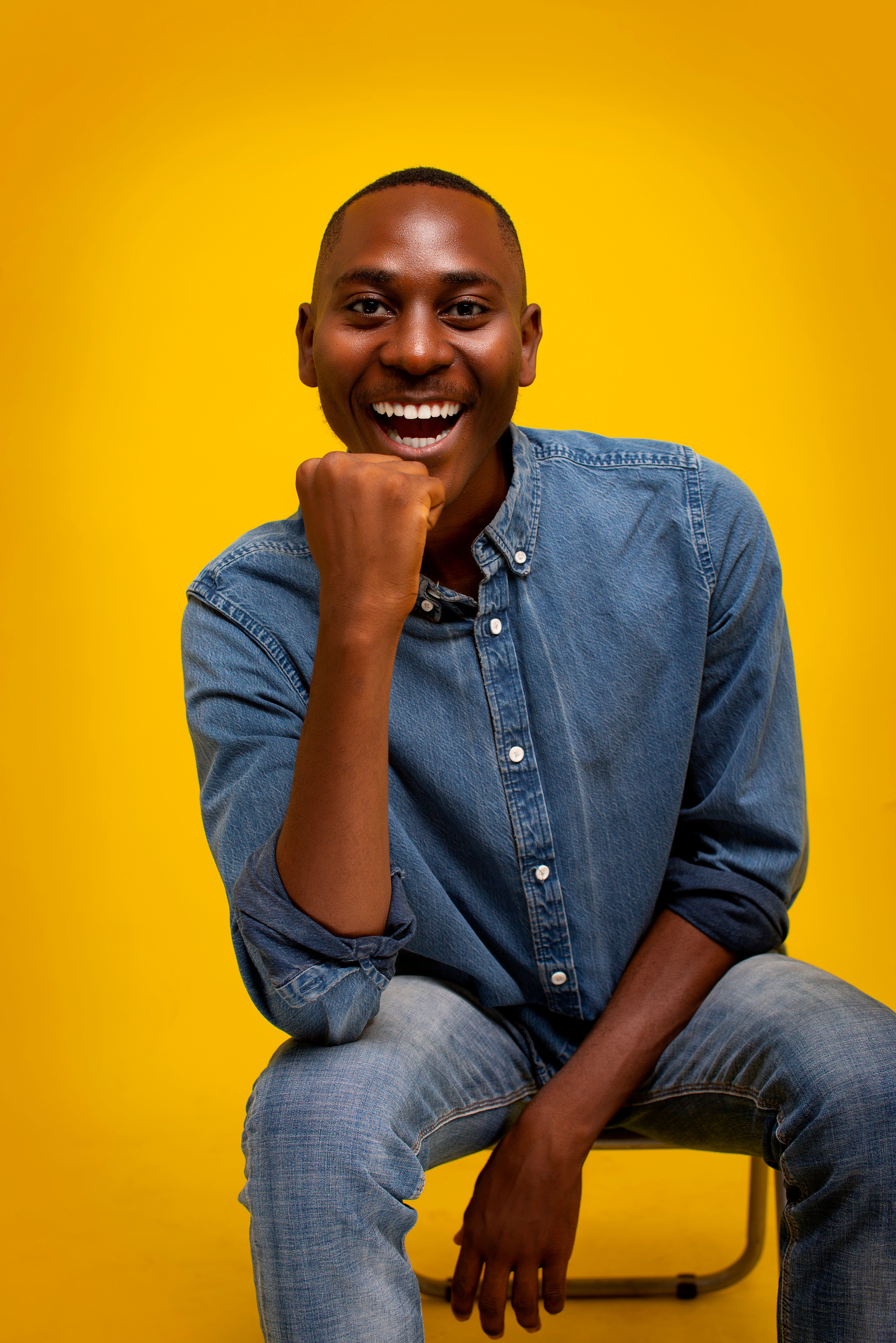 Smiling Young Man in Denim on Yellow Background · Free Stock Photo