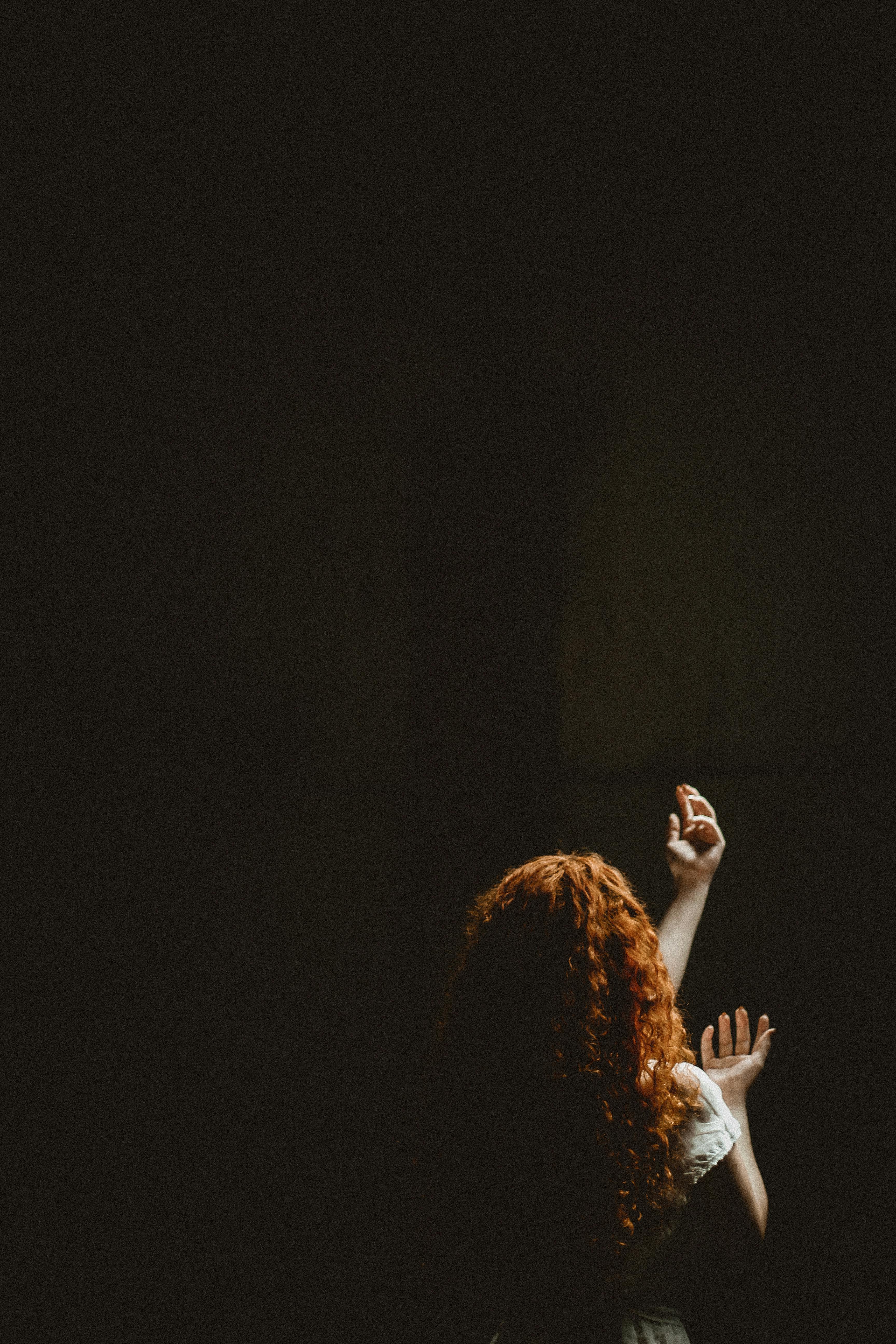 woman rising her hands