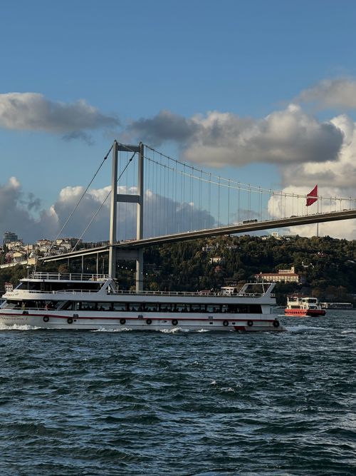 Free Ferry cruising under the Bosphorus Bridge with scenic Istanbul skyline. Stock Photo