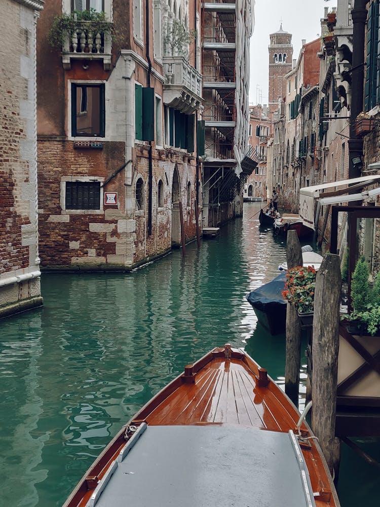 Brown Boat Along The Canals Of Venice