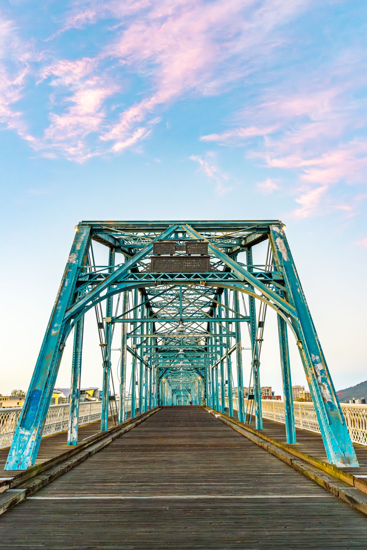 Symmetrical view looking down the Walnut Street Bridge pedestrian deck at sunrise