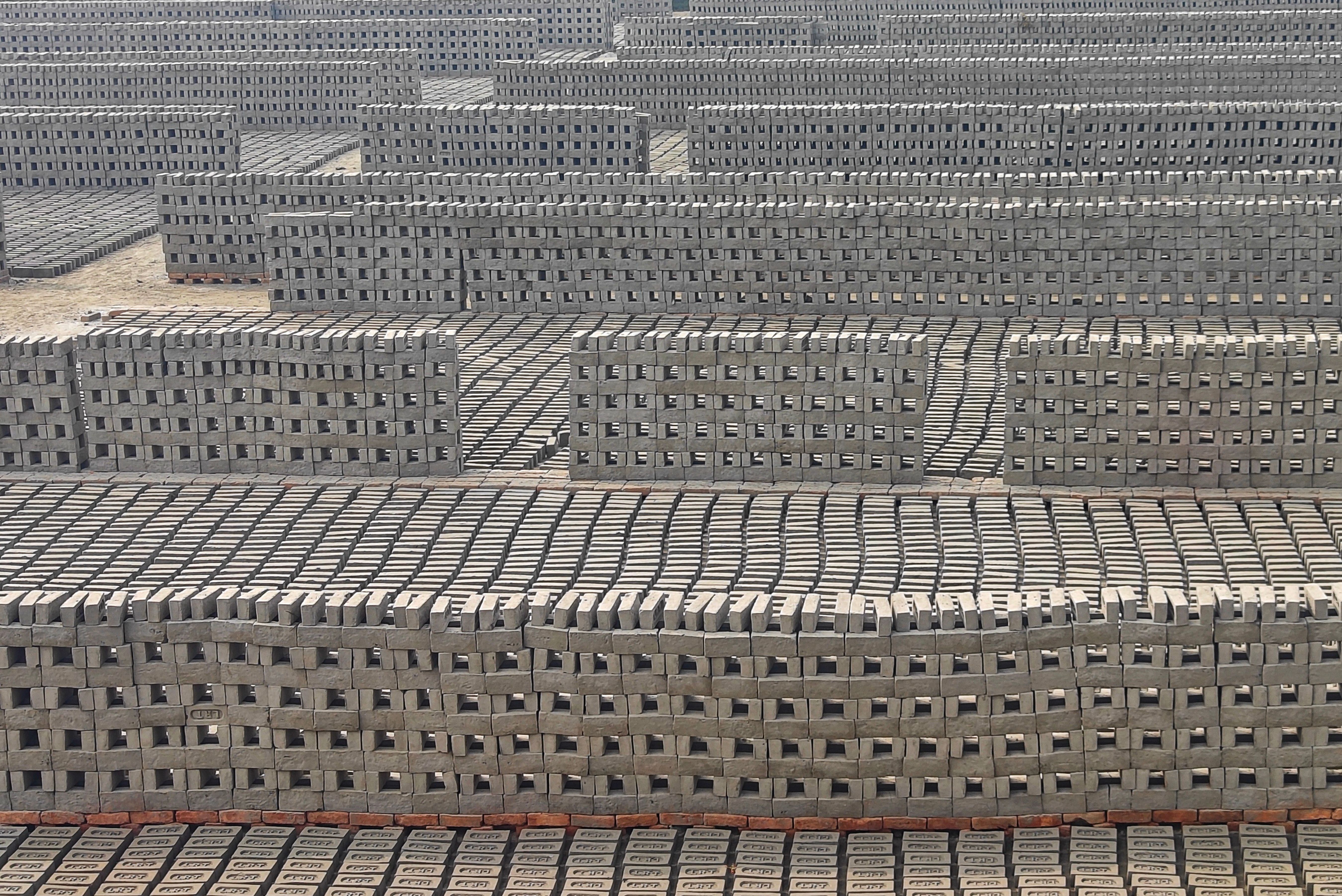 Stacks of bricks drying under the sun in Haroa, West Bengal, India.