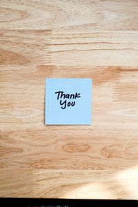 Handwritten thank-you note on a wooden table — photo by Airam Dato-on on Pexels