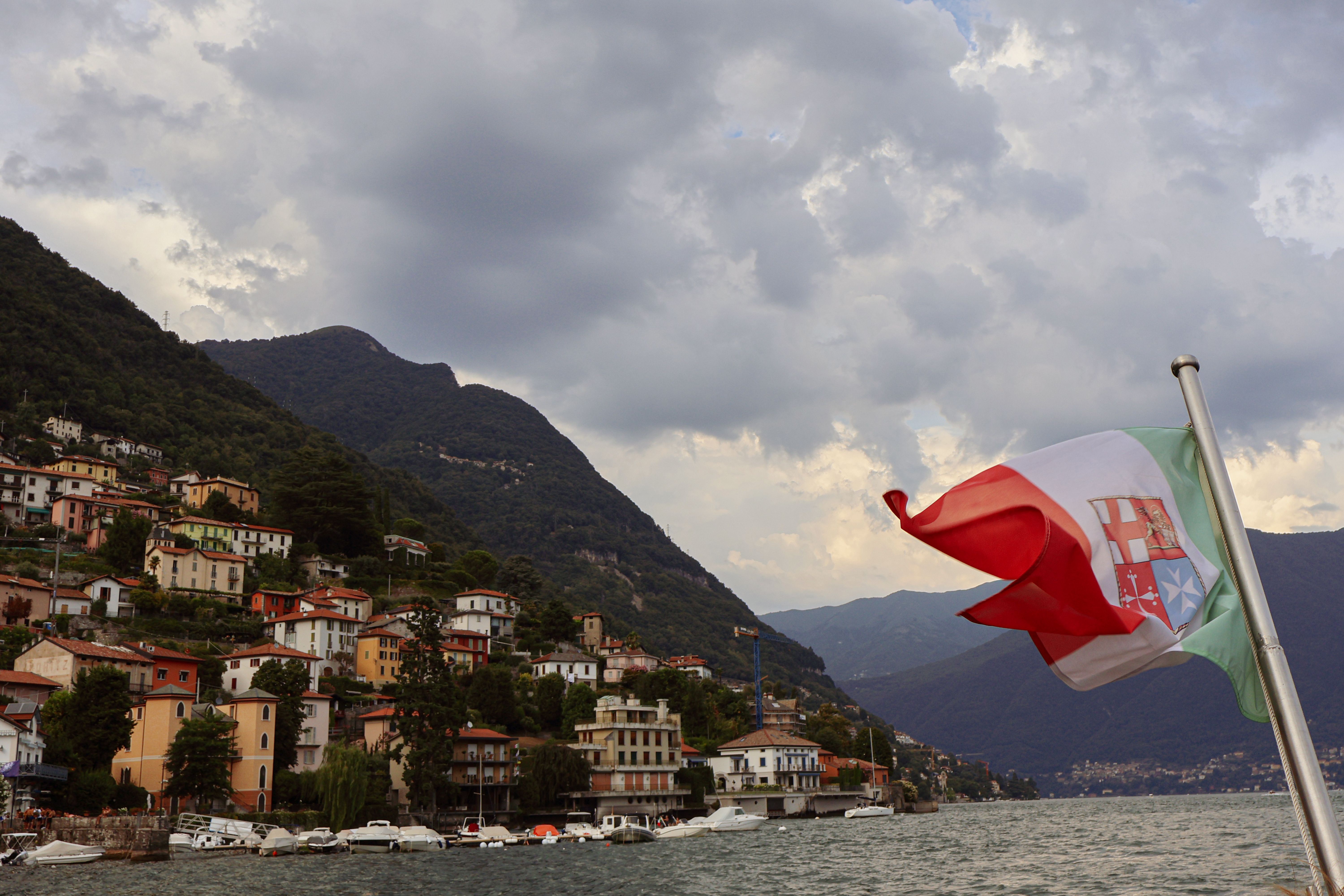Scenic View of Lake Como with Italian Flag · Free Stock Photo