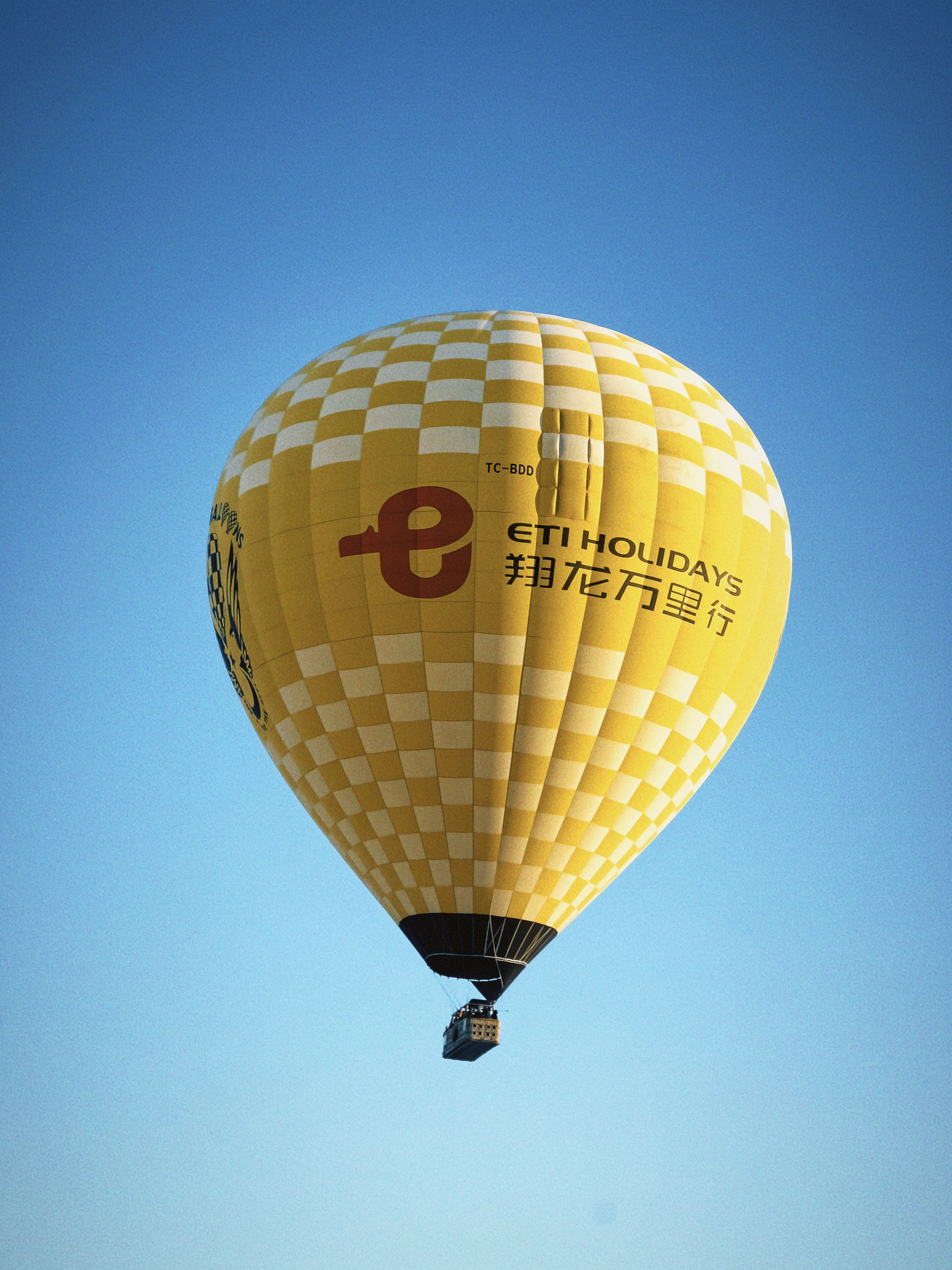 Yellow hot air balloon floating in clear sky · Free Stock Photo