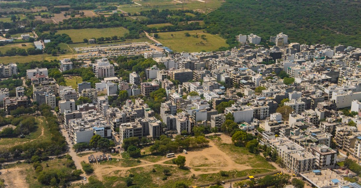 Stunning aerial view of Gurugram, India's vibrant urban landscape and green surroundings.