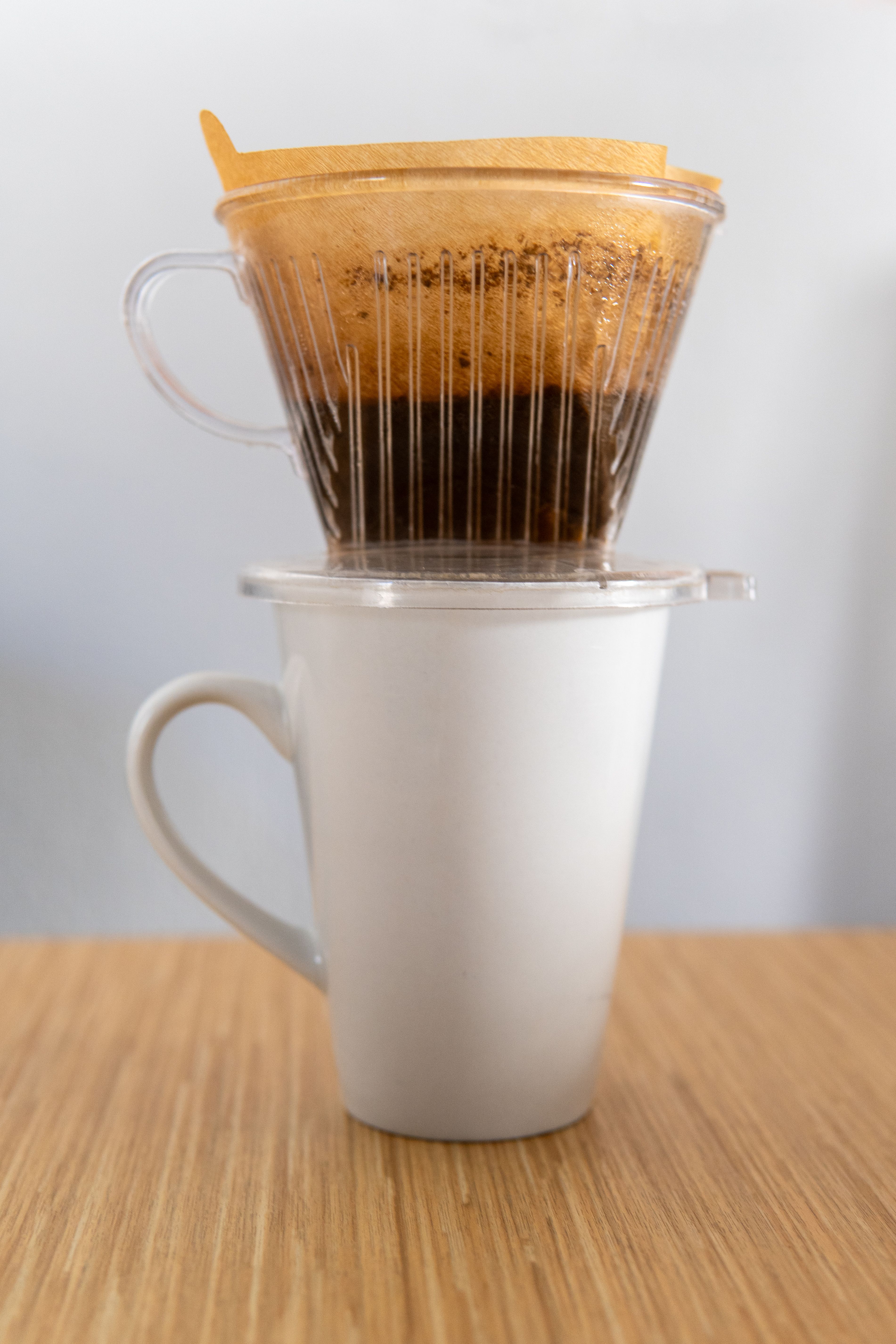Coffee being poured into a ceramic mug in warm morning light