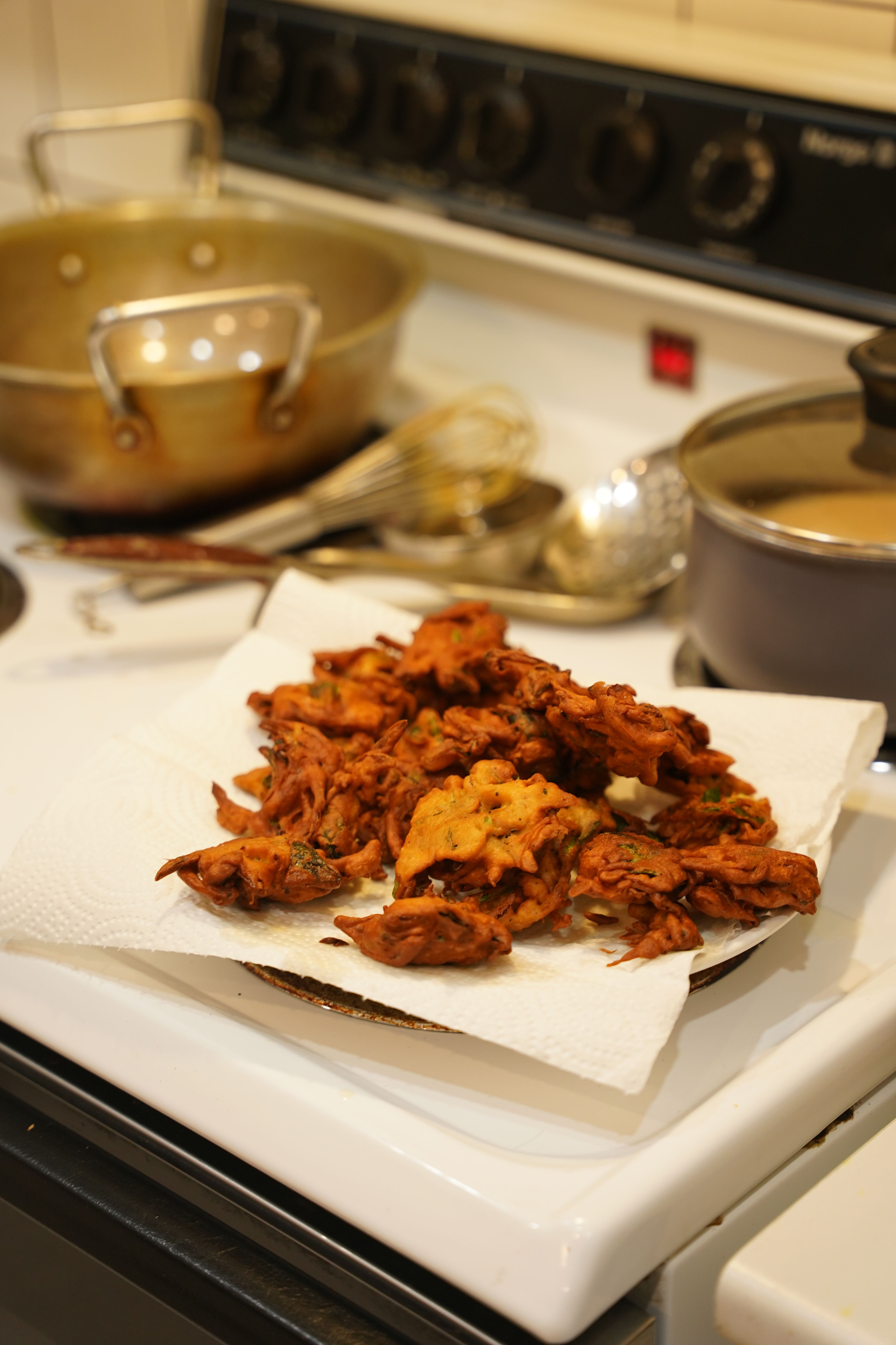 A chef plating vegetarian dishes in a warm kitchen